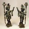 Pair 20th Century Bronze Nubian Torchieres. Unsigned. Oxidized patina. Measures 55" H x 27" W. Shipping: Third party