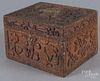 Carved pine lock box, 19th c., with relief decoration of figure and an animal in a forest landscapes
