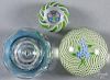 Three Perthshire glass paperweights, to include one with flowers on a latticino ground, marked