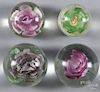 Four floral art glass paperweights, largest - 3 1/2'' dia.