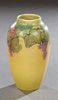 Rookwood Vellum Pottery Vase, 1929, shape #900C, by Sara Elizabeth Coyne, with grape and leaf decoration, H.- 8 3/4 in., Dia.- 5 in.