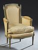 French Louis XVI Style Polychromed Bergere, 20th c., the canted curved upholstered back on tapered reeded supports to curved arms over a removable bow