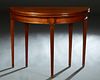 French Louis XVI Style Carved Cherry Demilune Games Table, 20th c., the ogee edge D-top over a wide skirt, on tapered reeded ormolu mounted square leg