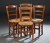 Set of Four French Provincial Carved Beech Rush Seat Dining Chairs, 20th c., the tapered canted ladder back over a woven rush seat, on tapered square 