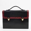 Yves Saint Laurent Briefcase, in black and red grained calf leather with gold hardware, opening to a black monogram canvas lined interior with one zip
