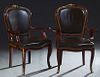 Pair of Ormolu Mounted Carved Mahogany Louis XV Style Armchairs, 20th c., the wide curved brown leather upholstered shield back with a bronze floral c