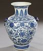Large Chinese Blue and White Porcelain Baluster Vase, 20th c., with applied Foo dog and ring handles, over leaf and floral decorated sides, the unders
