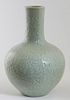 Chinese Celadon Porcelain Bottle Vase, 20th c., with relief floral and leaf decorated sides, the underside with a blue underglaze mark, H.- 13 1/4 in.