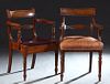 Two Similar English Carved Mahogany Armchairs, 19th c., one inlaid with a curved horizontal splat back over curved reeded arms and a pale brown leathe