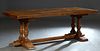 French Carved Oak Monastery Table, early 20th c., the 2 3/4 in. thick top on double urn form trestle supports joined by a rectangular stretcher, H.- 3