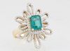 Lady's 14K Yellow Gold Dinner Ring, with a central 1.71 ct. emerald atop a pierced floriform border if tiny round diamonds, total diamond wt.- .57 cts