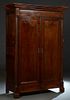 French Empire Style carved Walnut Armoire, 19th c., the stepped crown over setback double doors,flanked by demilune engaged reeded columns, on a plint