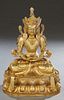 Gilt Bronze Seated Buddha, 20th c., on an integral relief dais throne, H.- 17 1/2 in., W.- 12 in., D.- 9 in.