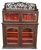 Anglo-Indian Carved Hardwood Cabinet, in two parts, 19th century, having two fitted cupboards with twin glass-front doors, elaborately carved back spl