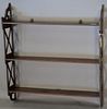 Mahogany hanging shelf having openwork sides and tiers of shelves, early 19th century.  ht. 29 in.; wd. 27 1/4 in.