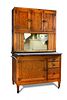 An early 20th century American oak and enamel kitchen unit by Hoosier, the three door cupboard top a
