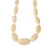 An early 20th century ivory bead necklace. Comprising fifty-six graduated oval beads measuring 1.3 t
