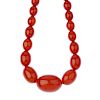 Three plastic bead necklaces. The first designed as a red plastic bead necklace, the flattened spher