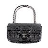 CHANEL - a black patent shoulder bag. Of rectangular shape with abstract floral and CC pattern, a si