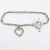 14 Karat White Gold Toggle Bracelet with Diamond Accented Heart Charm.
