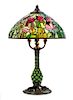 A Tiffany Studios Favrile Glass And Bronze Blown-Out Glass Tulip Lamp, Height overall 24 1/4 x diameter of shade 16 inches.