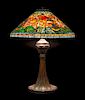 A Tiffany Studios Favrile Glass and Bronze Poppy Lamp, Height overall 26 1/4 x diameter of shade 20 inches.