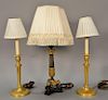 Three piece lot to include a pair of French ormolu brass candlesticks made into lamps and a French style candlestick with claw feet ...