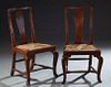 Pair of Irish Carved Oak Rushseat Side Chairs, 18th c., the curved crest rail over a vertical urn shaped splat, to trapezoidal rush slip seats, on poi
