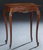 French Louis XV Style Carved Walnut Work Table, early 20th c., the crotched stepped lifting tortoise lid with an interior beveled mirror, above three 
