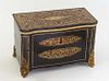 French Tahan Boulle Inlaid Ebonized Brass Mounted Tantalus Box, 19th c., the serpentine top opening to a pink silk lined interior fitted for three squ