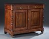 French Carved Walnut Louis Philippe Style Sideboard, late 19th c., the ogee edge cookie corner lifting top with two rear folding shelves, over two fri