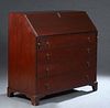 Large English Carved Inlaid Mahogany Slant Front Desk, 19th c., the slanted baize inset lid opening to an interior fitted with open storage, seven dra