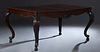 American Carved Mahogany Dining Table, 20th c., the stepped rounded corner top over a wide skirt, on four carved cabriole legs, with two leaves, H.- 3