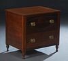 Contemporary Custom Made Carved Walnut Lamp Table, 20th c., the rectangular top over a bank of two deep drawers with octagonal brass pulls, on turned 