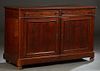 French Provincial Carved Walnut Louis Philippe Sideboard, 19th c., the rounded edge and corner top over two frieze drawers, above double cupboard door