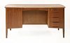 A Danish teak desk,<BR>with a cupboard and drawers to the front, and two shelves to the reverse,<BR>