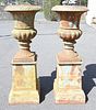 Pair of Iron Urns on Square Pedestals, height 55 inches, inside diameter 16 inches.