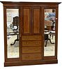 Edwardian Mahogany Armoire, having two large doors, drawers, and small doors, height 76 inches, width 82 1/2 inches, depth 23 inches.