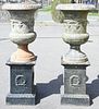 Pair of Iron Urns on Square Pedestals, total height 60 inches, inside diameter 18 1/2 inches.