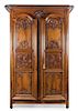 A French Provincial Carved Fruitwood Armoire Height 96 x width 66 x depth 39 inches.