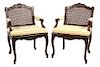 A Pair of Louis XVl Style Carved Walnut Fauteuils Height 35 inches.