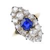 A sapphire and diamond cluster ring. The cushion-shape sapphire, within an old-cut diamond marquise-