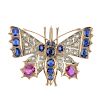 A diamond and gem-set brooch. Designed as a butterfly, set throughout with vari-cut rubies, sapphire