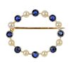 An early 20th century gold sapphire and seed pearl wreath brooch. Comprising an alternating circular
