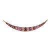 An early 20th century 9ct gold garnet crescent brooch. Set throughout with graduated circular-shape