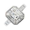 A platinum diamond cluster ring. The rectangular-shape diamond, within a tapered baguette-cut diamon