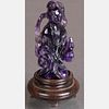 A Chinese Carved Amethyst Figure of Guanyin on a Carved Hardwood Stand.