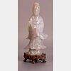 A Chinese Carved Nephrite Jade Figure of Guanyin on a Carved Hardwood Stand.