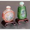 Two Peking Glass Snuff Bottles with Painted Interiors on Carved Hardwood Stands,