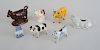 GROUP OF FOUR POTTERY COW CREAMERS, A YELLOW CAB" COW, A BLACK-SPOTTED COW AND A COW-FORM TOOTH PICK HOLDER"